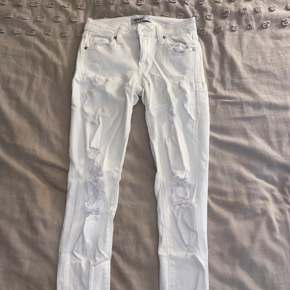 Distressed white skinny jeans